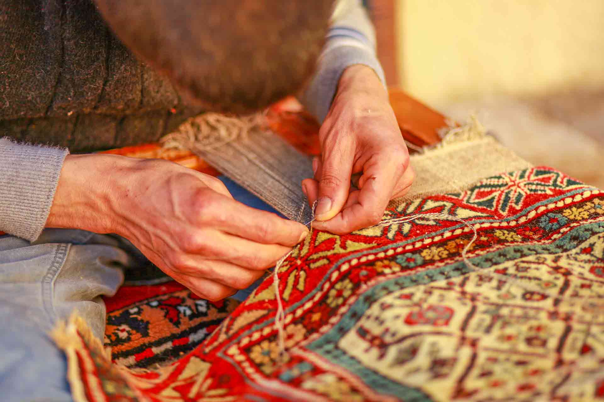 Rug repair specialist at work
